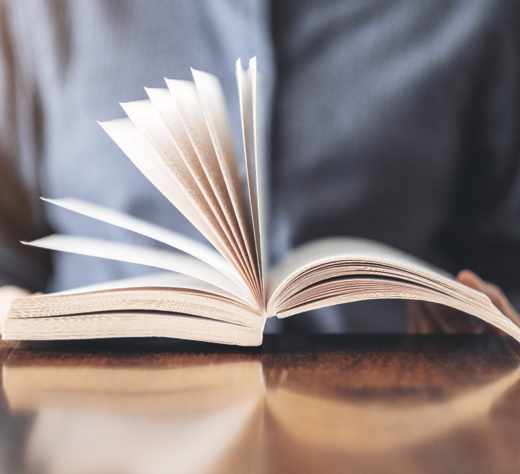 closeup-image-of-a-woman-holding-and-reading-book