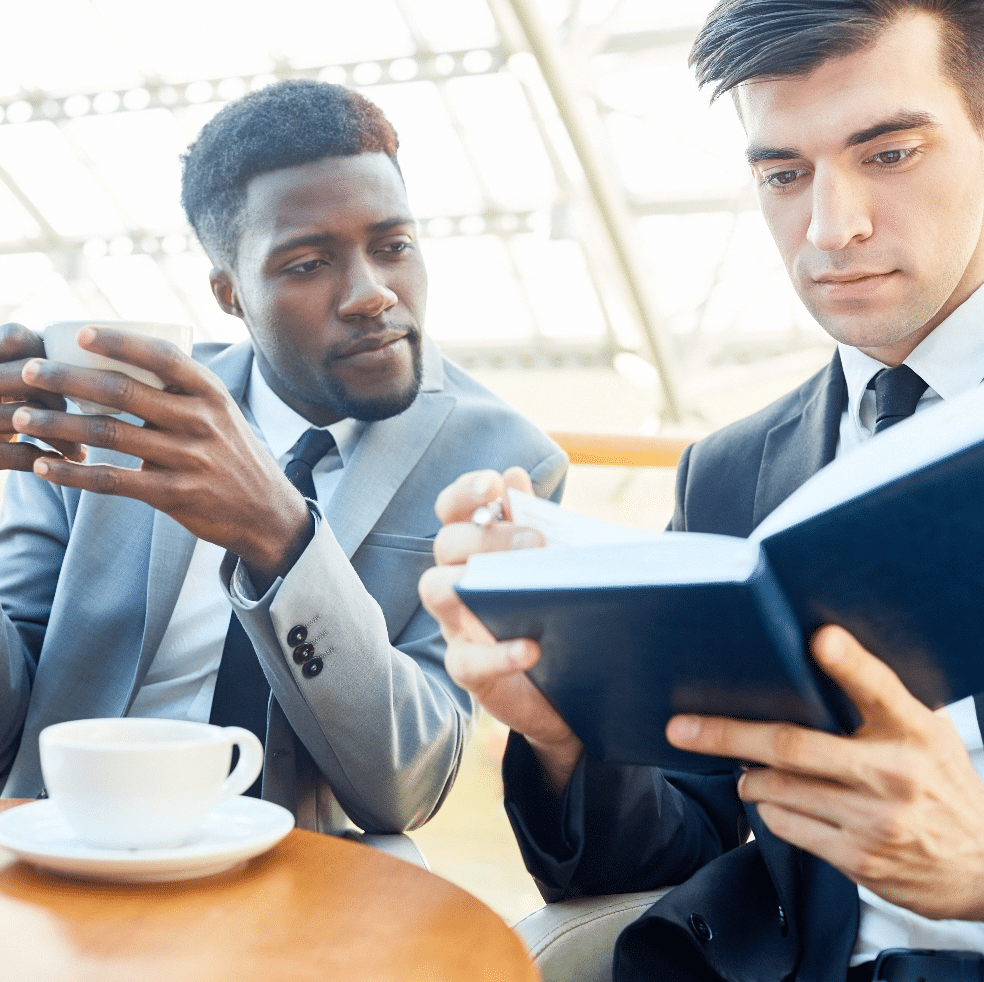 businessmen-discussing-notes-in-modern-office-building