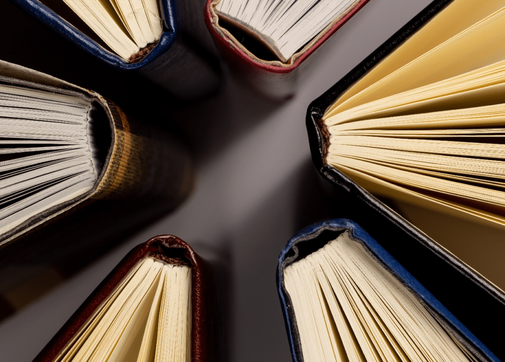 stack-of-open-books-with-colorful-covers-2026-03-25-02-53-00-utc@2x